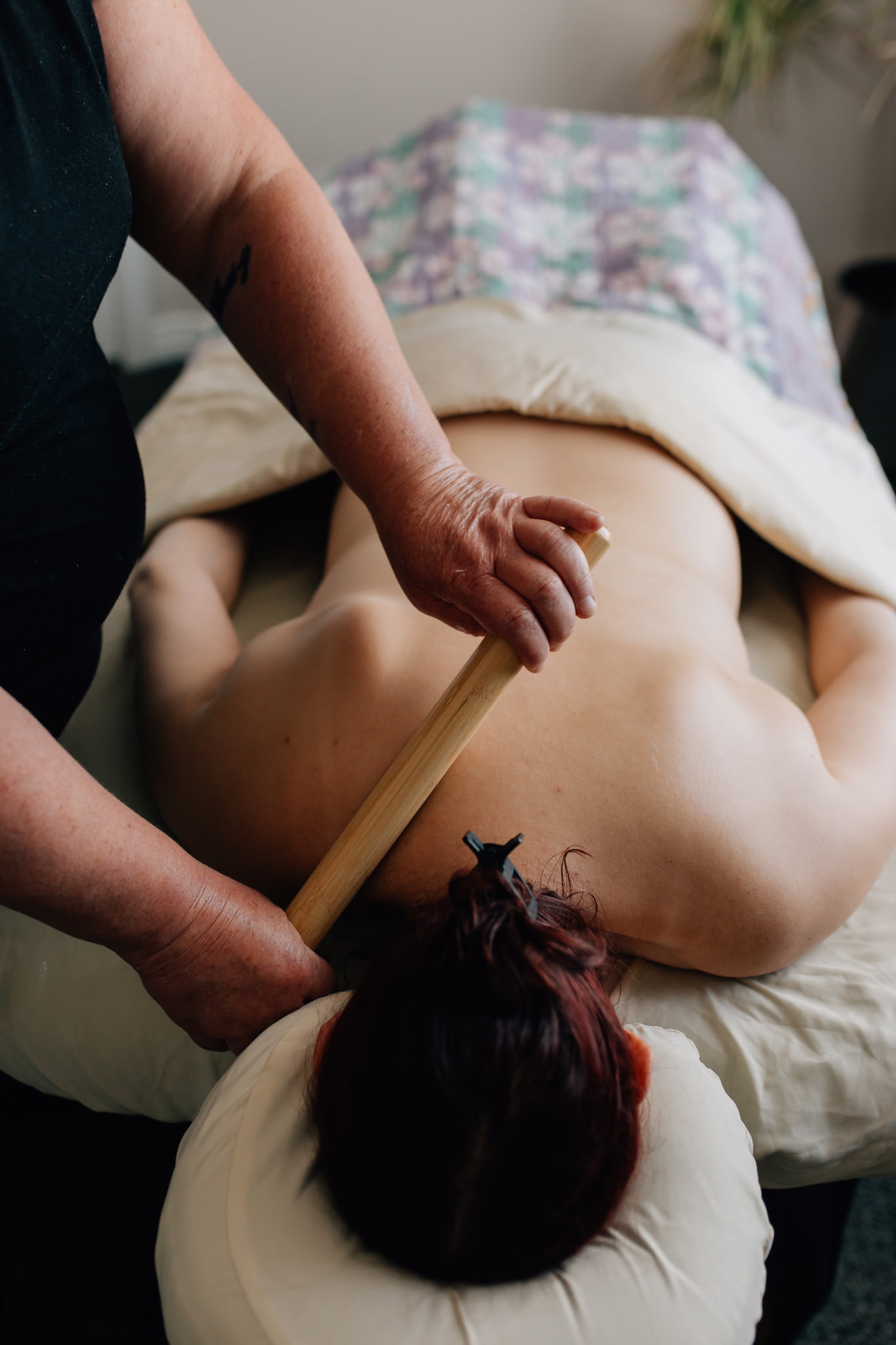 Warm bamboo massage technique on the back in Murray, Utah